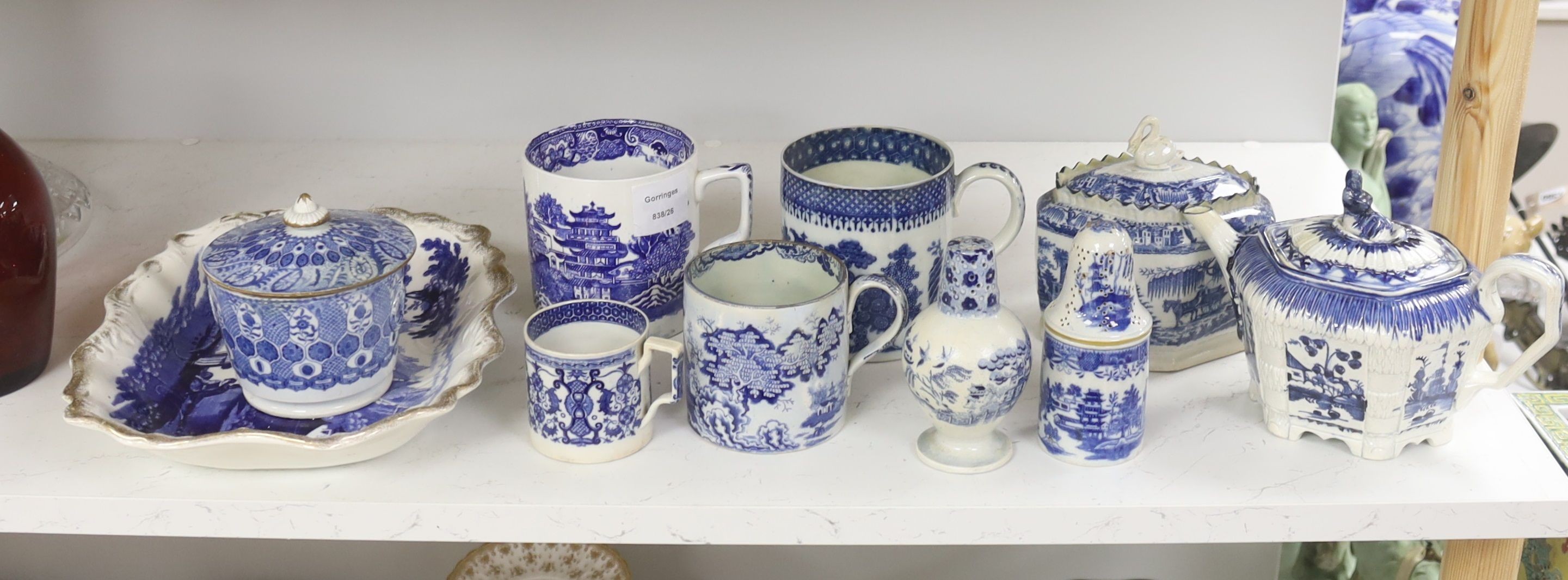 A collection of English blue and white pottery, various dates, comprising a moulded hexagonal teapot and cover, with widow finial, ovoid teapot and cover, lozenge section sugar bowl and cover, with swan finial, circular